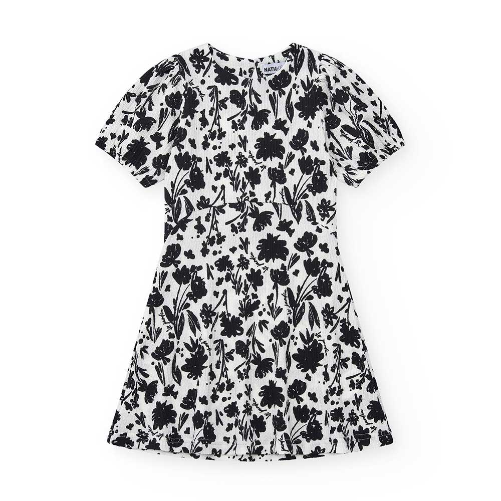 Dress in crepe from the Nath Kids Girls' Clothing Line, with a black floral pattern on white.Comp...