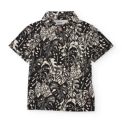 Polo a maniche corte con stampa tropicale in bianco e nero.