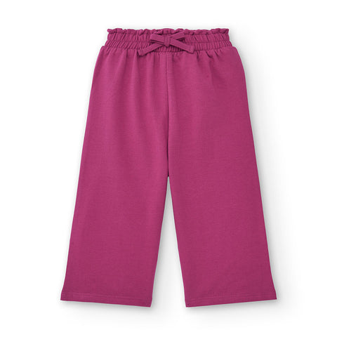 Pantaloni ampi di colore fucsia per bambina con elastico in vita.